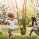 Cute african american little girl playing outdoor - Black people kid and friend happy.