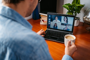 Man having a coffee time from home on video call with friends. Epidemic lockdown.