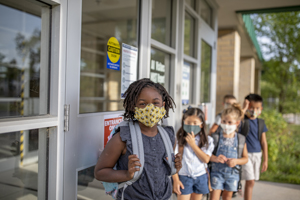 Group of kids return to school during the pandemic.