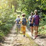 Mother and three kids hiking in forest. Family is having great time together.
Nikon D850