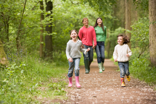 Family walking on path smiling